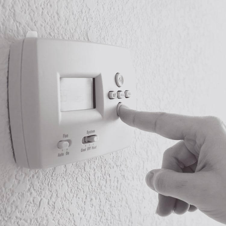 finger pushing thermostat