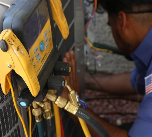 Technician doing HVAC maintenance