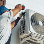 repairman in uniform installing the outside