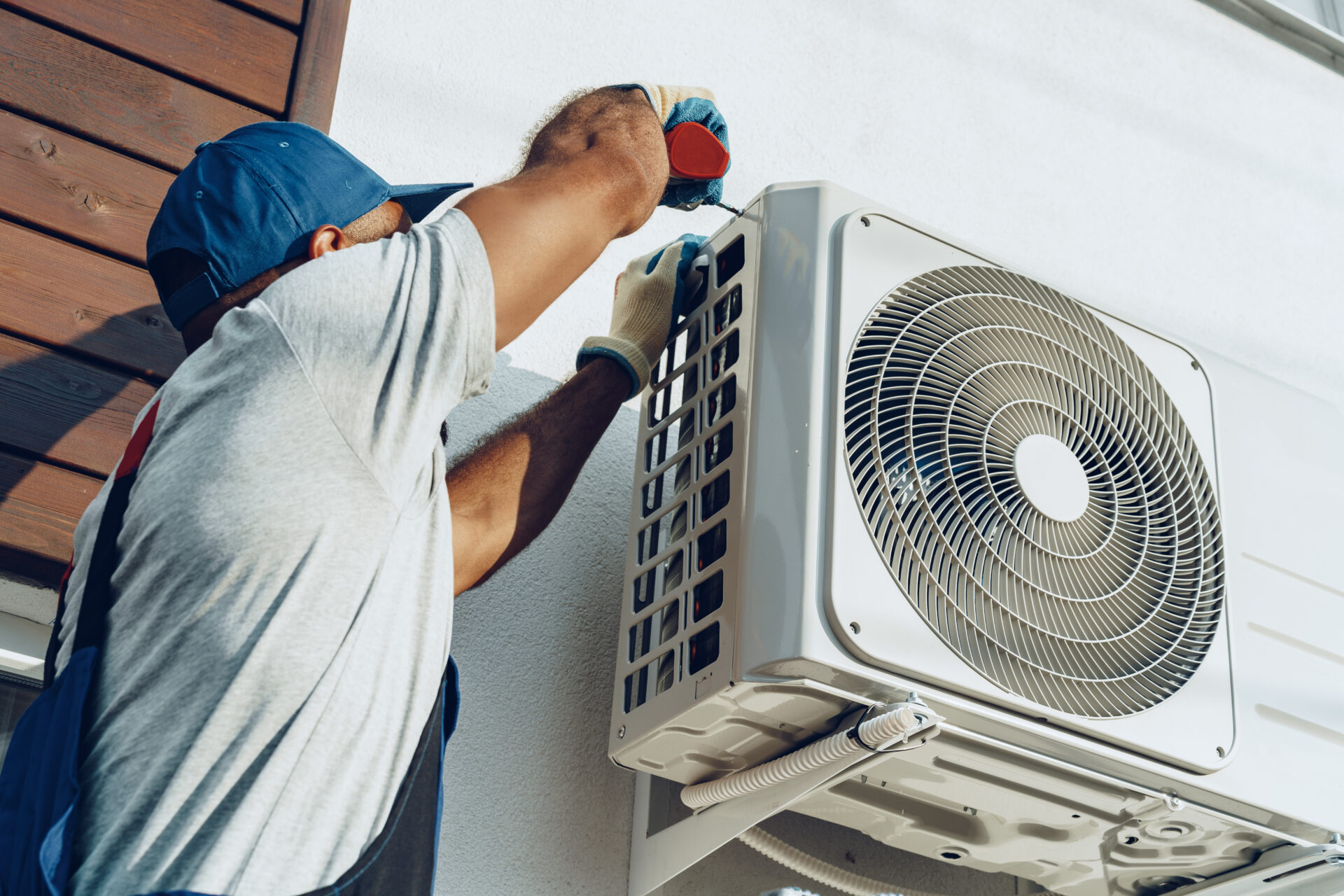 repairman in uniform installing the outside