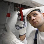 worker repairing air conditioner